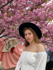 portrait of a woman next to cherry blossom