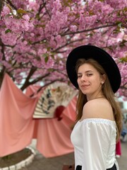 portrait of girl next to cherry blossom