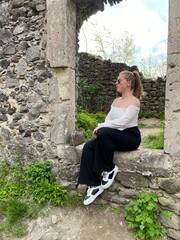 person sitting on a stone wall