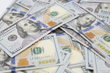 Pile of 100 dollar bills scattered in a heap. Close up view.