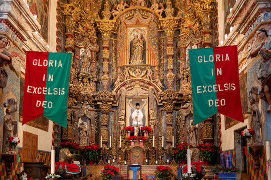 Tucson, Arizona - December 23, 2023: Interior of San Xavier del Bac Mission, Tohono O'odham Reservation, with a Christmas banner Gloria In Excelsis Deo