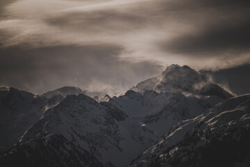 Fototapeta premium strong south wind in the alps at a cloudy and sunny winter day in the national park hohe tauern in austria