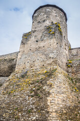 The part of Old Kamianets-Podilskyi Castle under a cloudy sky. Powerful bastions and towers of the...