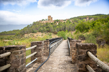 Fototapeta premium a pedestrian bridge with a view of Ruesta, municipality of Urriés, region of Cinco Villas, province of Zaragoza, Aragon, Spain