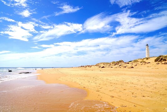 view from the beach towards the Faro de Trafalgar lighthouse, sandy headland between Los Ca&ntilde;os de Meca and Zahora, Vejer de la Frontera, Costa de la Luz, Andalusia, Spain