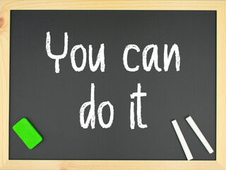 Blackboard with the words you can do it written in white with two chalks and a green eraser