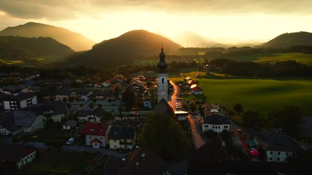 Alps Mountain Aerial sunrise in the mountains.Mountain Range Silhouette Sunrise Aerial View. Scenic Dawn Sunlight Mountainous Cottage Village Overview.
