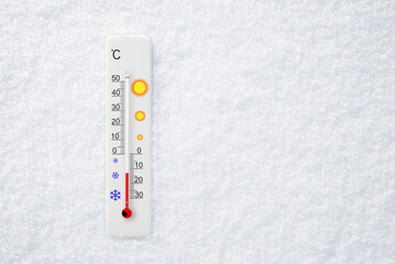 White celsius scale thermometer in snow. Ambient temperature minus 13 degrees celsius