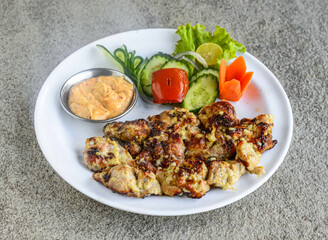 chicken malai boti tikka kabab with salad and mayonnaise dip served in dish isolated on grey background side view of indian spices and pakistani food