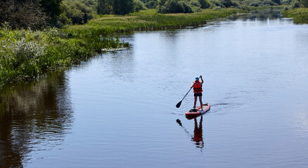 Paddleboarding on lake, aerial view. Stand up paddle boarding (SUP) water sport.