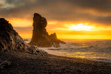Sunset over the volcanic lava formations of Djupalonssandur beach,  Iceland