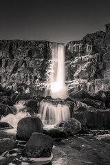 Landscape in black and white of Oxararfoss waterfall in Thingvellir National Park,  Iceland. 