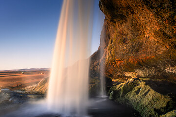 Amazing view from behind the Seljalandsfoss Waterfall at sunset,  Iceland