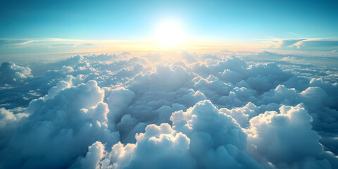 Sunrise over white fluffy soft clouds on blue skyline, plane top aerial view. Beautiful cloudscape.