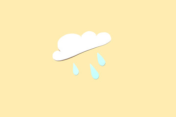 Paper cloud with rain drops on beige background. Weather forecast concept
