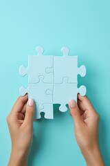 Four puzzle pieces in Caucasian female hands on blue background,