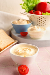 Bowl of tasty cream cheese on table