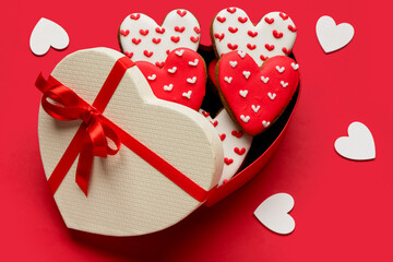 Gift box with heart shaped cookies on red background. Valentine's day celebration