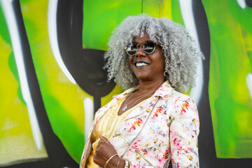 Stylish afro-american woman with grey afro hair, outdoors