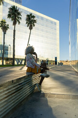 Afro-american lady with smart-phone in urban environment
