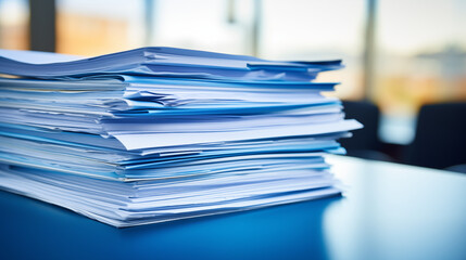 Documentación ordenada en carpetas de color azul sobre una mesa de madera 