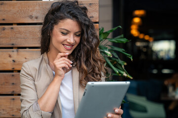 Beautiful confident businesswoman manager with hand on chin taking care of her business working on...