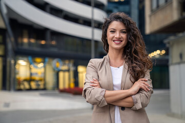 Happy smiling confident female leader businesswoman standing outside the modern office workplace...
