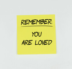 Yellow Post-it with the phrase Remember: you are loved written in black, with a white background