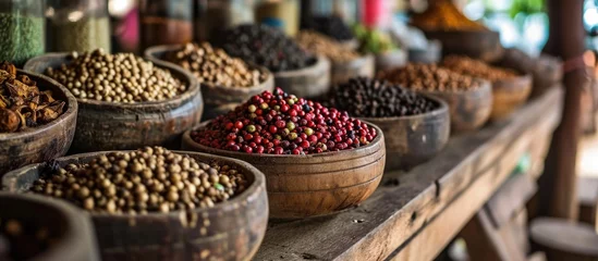 Tapeten Display of organic pepper corns in rustic wood in Kampot, Cambodia. © TheWaterMeloonProjec