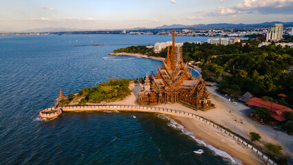 The Sanctuary of Truth wooden temple in Pattaya Thailand at sunset, drone aerial view at the wooden...