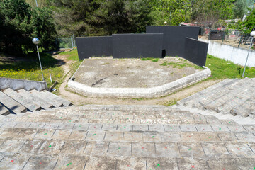 empty amphitheater with cement seats and black stage background in the peace and friendship park in...