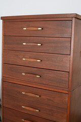 Vintage tall dresser with gorgeous walnut wood grain and brass hardware details. Vintage 1960s bedroom furniture.
