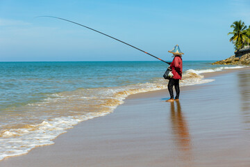 Thailand. Kao-Lak. A woman is fishing on the seashore.