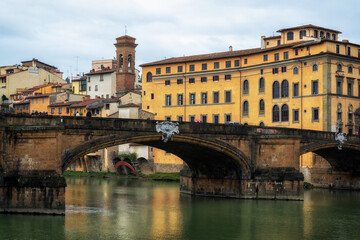 Winter rainy Florence. Bridges over the Arno River and Medieval Architecture.