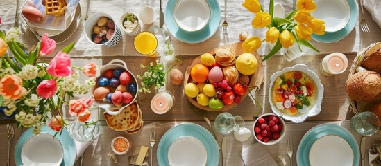 Top view of Easter meal table setting for breakfast or brunch with loved ones. - obrazy, fototapety, plakaty