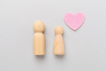 Wooden couple in love on color background, top view. Creative valentine's day composition