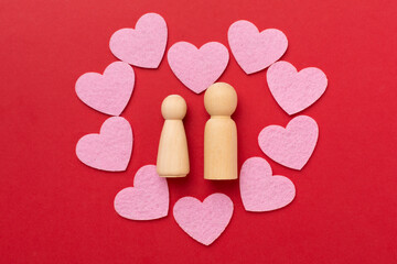 Wooden couple in love on color background, top view. Creative valentine's day composition