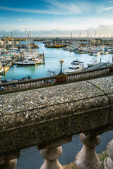 Ramsgate Royal Harbour seen beyond the balustrades of the Royal Parade in the Isle of Thanet, Kent,...