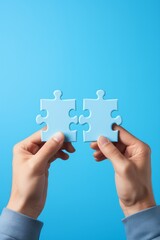 Two hands holding puzzle pieces to complete the puzzle