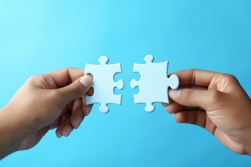 Two Hands Holding Puzzle Pieces to Complete the Puzzle,