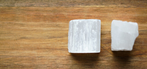 Piece of natural selenite on the wooden background. 