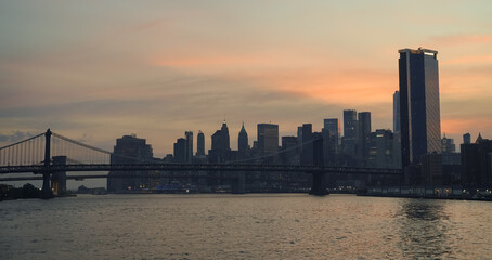 Fototapeta premium New York view during the afternoon with its skyline, Brooklyn Bridge, Manhattan Bridge, and Hudson River