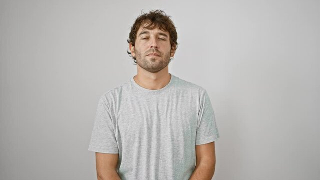 Confident young man with a cool yet earnest look, sporting a simple t-shirt. his serious expression is both natural and trusting, peering into the camera over a white isolated background.