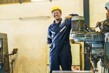 Smart and good looking senior factory or mechanical engineer standing in the factory portrait.