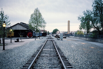 Grainy film photograph of railroad tracks at Old Sacramento State Historic Park in central...