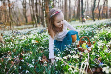 Five year old girl playing egg hunt on Easter