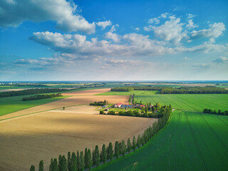 Naklejka premium Aerial drone view of green fields and meadows in Yveliness,, near Paris, France
