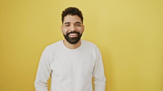 Merry young man pulling a wacky fish face, puckering up his lips for a comical kiss! standing isolated on a sunny yellow background, his crazy yet confident expression radiates fun.