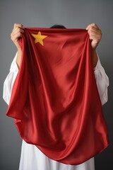 A person holding a Chinese flag