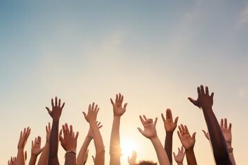 People of different ethnicities raising their hands in the air